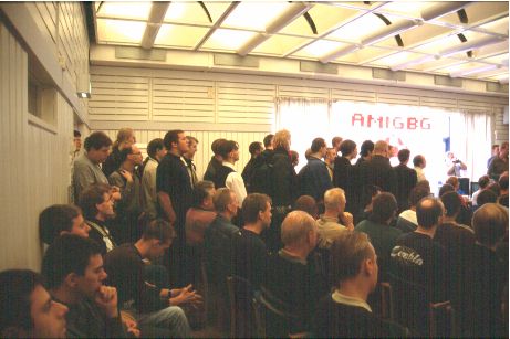 3: An amazing amount of people had showed up. They were standing all the way out into the hallway. I managed to sneak my way into the corner of the room where I had spotted a little free space so I could get some pictures.