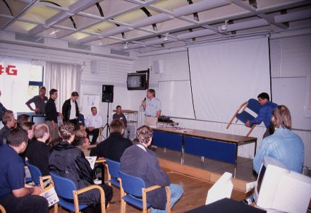 14: Alan Redhouse of Eyetech telling us about the progress of the AmigaOne and OS4. On the table next to him is a prototype of the next AmigaOne model which will come with a processor daughtercard, so you can upgrade the CPU.
