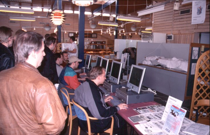 9: Genesi's stand. Not like in Aachen, but still an eye-catching demonstration setup. Pity it didn't work so well, as e.g. the infrared mice had trouble communicating with their receivers, and the keyboards were more pretty than practical. Oh well. Have a T-shirt, man.