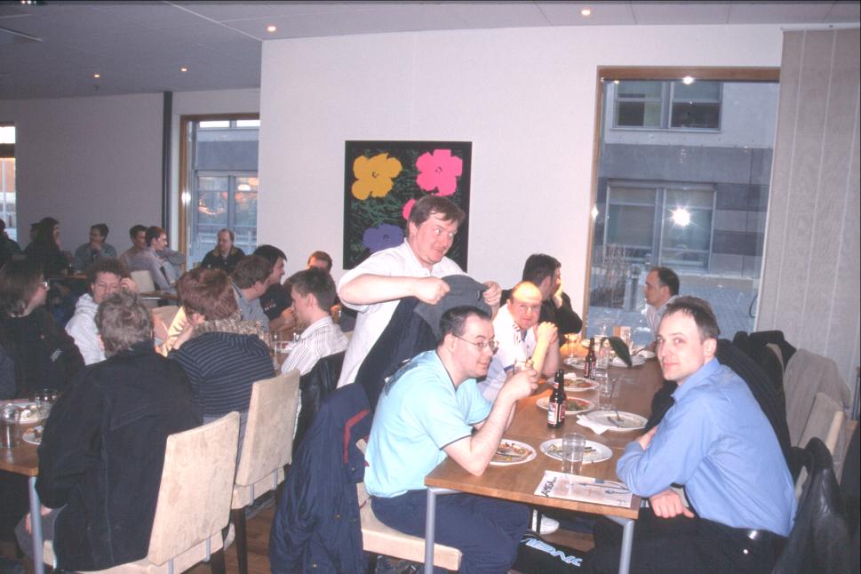 Rigo: "I'll trap him inside my coat, and then we'll sell him into Swedish white slavery and use the gains to buy AmigaOnes at the show tomorrow". Paul, Rigo, L8X, Jens Sch&ouml;nfeld across from Paul.